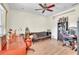Office space featuring a wooden desk, a futon, shelves, and wood-style laminate flooring at 9950 W Lake Marion Rd, Haines City, FL 33844