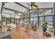 Bright sunroom with floor-to-ceiling windows, wood floors, and lake views at 9950 W Lake Marion Rd, Haines City, FL 33844