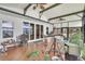 Spacious sunroom features lots of light, lake views, and wood-look floors at 9950 W Lake Marion Rd, Haines City, FL 33844