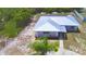 An aerial view of a charming single-story home with a metal roof and mature landscaping at 101 Babson Heights Dr, Babson Park, FL 33827
