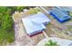 Aerial shot of a home showing a metal roof, surrounding yard and the neighboring property at 101 Babson Heights Dr, Babson Park, FL 33827