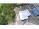 Aerial view of property showcasing house, surrounding vegetation, and the metal roof at 101 Babson Heights Dr, Babson Park, FL 33827