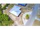 Aerial view showing the house with modern metal roof and surrounding street and nearby trees at 101 Babson Heights Dr, Babson Park, FL 33827