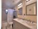 Bathroom featuring a double sink vanity with modern fixtures and a shower/tub with decorative tile at 101 Babson Heights Dr, Babson Park, FL 33827