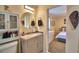 Bright bathroom features a modern vanity with a round mirror, and storage cabinet at 101 Babson Heights Dr, Babson Park, FL 33827