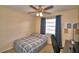 Cozy bedroom with a ceiling fan, grey curtains, and a comfortable work space at 101 Babson Heights Dr, Babson Park, FL 33827