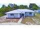 Charming single-story home with a metal roof, freshly painted exterior and landscaped front yard at 101 Babson Heights Dr, Babson Park, FL 33827