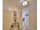 Inviting foyer with a decorative light fixture, tiled flooring, and glass topped table at 101 Babson Heights Dr, Babson Park, FL 33827