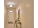 Inviting foyer with a decorative light fixture, tiled flooring, and glass topped table at 101 Babson Heights Dr, Babson Park, FL 33827