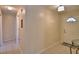 Bright hallway with a decorative light fixture and tiled flooring leads to front door at 101 Babson Heights Dr, Babson Park, FL 33827