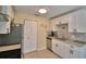 Modern kitchen with white cabinetry, granite countertops, stainless steel appliances, and tile flooring at 101 Babson Heights Dr, Babson Park, FL 33827