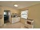 Cozy kitchen with white cabinetry, tile floors, and a breakfast nook featuring shelves with appliances and cookware at 101 Babson Heights Dr, Babson Park, FL 33827