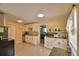Open kitchen featuring white cabinetry, granite counters, tile flooring, breakfast nook, and stainless steel appliances at 101 Babson Heights Dr, Babson Park, FL 33827