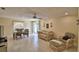 Open living room featuring tiled flooring, seating area with tan sofa and chair, dining table set near the sliding doors at 101 Babson Heights Dr, Babson Park, FL 33827