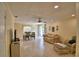 Open concept living room with tile floors, dining table with chairs, ceiling fan, and cozy seating arrangement at 101 Babson Heights Dr, Babson Park, FL 33827