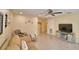 Cozy living room with tiled floors, ceiling fan and comfortable seating arrangement with tan sofa and neutral-toned walls at 101 Babson Heights Dr, Babson Park, FL 33827