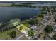 Aerial view of lakeside homes surrounded by lush trees and tranquil water, property lines shown at 1010 Biltmore Nw Dr, Winter Haven, FL 33881