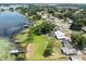 Aerial view of a lakeside property with lush greenery, docks, and calm waters at 1010 Biltmore Nw Dr, Winter Haven, FL 33881