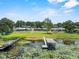 Aerial view of the property with docks, lake, and lush surroundings at 1010 Biltmore Nw Dr, Winter Haven, FL 33881