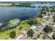 Aerial view of lakeside homes surrounded by lush trees and tranquil water at 1010 Biltmore Nw Dr, Winter Haven, FL 33881