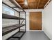 Basement with painted walls and wood beam ceiling ready for storage solutions at 1010 Biltmore Nw Dr, Winter Haven, FL 33881