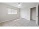 Bright, open bedroom with tile flooring, a ceiling fan, and built in closet space at 1010 Biltmore Nw Dr, Winter Haven, FL 33881