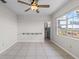 Bright bedroom with tile flooring and large windows offering waterfront views at 1010 Biltmore Nw Dr, Winter Haven, FL 33881