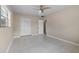 Clean, light-filled bedroom with tiled floors, neutral walls, and a double door closet at 1010 Biltmore Nw Dr, Winter Haven, FL 33881