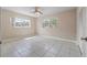 Bright bedroom features tile flooring and natural light at 1010 Biltmore Nw Dr, Winter Haven, FL 33881