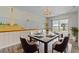 Elegant dining room with mural art, modern lighting, and a view of the lake at 1010 Biltmore Nw Dr, Winter Haven, FL 33881