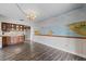 Dining area with mural, wood floors, adjacent to kitchen and entry at 1010 Biltmore Nw Dr, Winter Haven, FL 33881