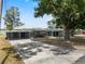 Charming single-story home with covered parking, a spacious front yard and mature trees at 1010 Biltmore Nw Dr, Winter Haven, FL 33881