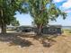Charming gray home with large trees in the front yard at 1010 Biltmore Nw Dr, Winter Haven, FL 33881