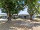 Charming gray home with mature trees in the front yard at 1010 Biltmore Nw Dr, Winter Haven, FL 33881