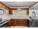 Efficient kitchen with wooden cabinets, stainless steel appliances, and ample counter space at 1010 Biltmore Nw Dr, Winter Haven, FL 33881