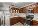 Traditional kitchen featuring wood cabinets, stainless steel appliances, and bright light from the large window at 1010 Biltmore Nw Dr, Winter Haven, FL 33881