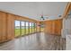 Bright living room with wood paneling, large windows overlooking the lake and durable flooring at 1010 Biltmore Nw Dr, Winter Haven, FL 33881