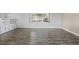 Spacious living room featuring neutral walls, wood-look floors, and a built-in bookcase at 1010 Biltmore Nw Dr, Winter Haven, FL 33881