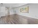 Bright living room features wood-look flooring, built-in storage, and a large window at 1010 Biltmore Nw Dr, Winter Haven, FL 33881