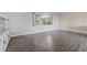 Spacious living room featuring neutral walls, wood-look floors, and a built-in bookcase at 1010 Biltmore Nw Dr, Winter Haven, FL 33881