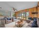 Spacious living room with wood paneling, ceiling fan and stunning lake views at 1010 Biltmore Nw Dr, Winter Haven, FL 33881