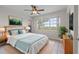 Bedroom with a large window offering water views, complemented by cool tones in the bedding and stylish decor at 1010 Biltmore Nw Dr, Winter Haven, FL 33881