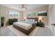 Stylish bedroom with a luxurious bed, decorative lighting, and bright windows creating a serene and inviting space at 1010 Biltmore Nw Dr, Winter Haven, FL 33881
