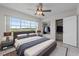 Comfortable bedroom with a water view, closet storage, and a large bed, decorated with lamps and stylish linens at 1010 Biltmore Nw Dr, Winter Haven, FL 33881