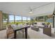 Relaxing sunroom with comfortable seating, table, and beautiful lake views through large windows at 1010 Biltmore Nw Dr, Winter Haven, FL 33881