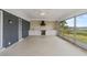 Open sunroom with an outdoor kitchen featuring brick and a sink overlooking the lake at 1010 Biltmore Nw Dr, Winter Haven, FL 33881