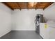 Utility room with wooden ceiling, washer, and a newer hot water heater at 1010 Biltmore Nw Dr, Winter Haven, FL 33881