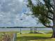 Picturesque view of lake with dock and seaplane in the distance at 1010 Biltmore Nw Dr, Winter Haven, FL 33881