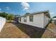 Back of home with a screened-in porch in a fenced yard at 1055 Sunshine Sw Way, Winter Haven, FL 33880