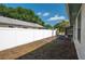 A fenced backyard with grass and landscaping near the home at 1055 Sunshine Sw Way, Winter Haven, FL 33880